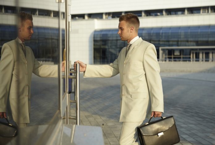 Portrait,Of,Businessman,In,Office,Doors