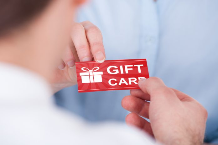 Close-up,Of,Two,Hands,Holding,Gift,Card
