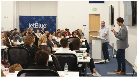 Adobe’s Allen Partridge (at podium) and Publicis Groupe’s Joseph Leslie dive into AI.