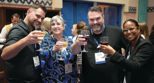 A concerted effort: Raising a glass to training at the conference kickoff. PHOTOGRAPHY BY HUGHES FIORETTI PHOTOGRAPHY