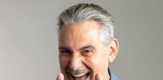 Photo of Josh Cavalier holding up both hands