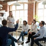 Unveiling the Importance of Harassment Prevention Training work colleagues sitting in a circle discussing something.