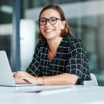 Skills Training as a Catalyst for Admin Career Advancement woman sitting at a desk with her computer.