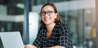 woman sitting at a desk with her computer.
