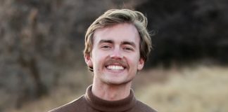 Photo of Ethan Webb with moustache and wearing brown turtleneck